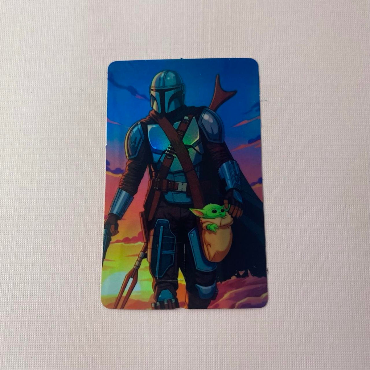 Mandalorian carrying Grogu